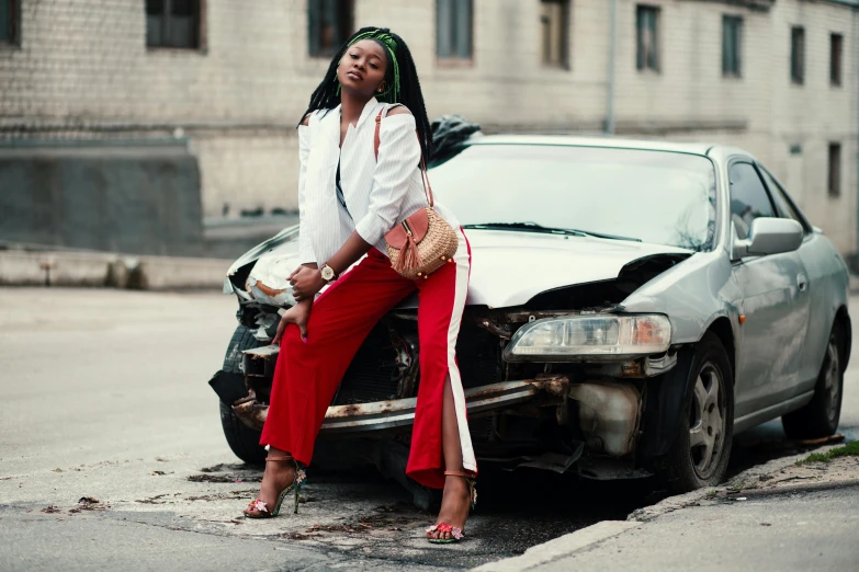 a woman sitting on the hood of a car, trending on pexels, auto-destructive art, black red white clothes, african woman, cars crashed, wearing off - white style