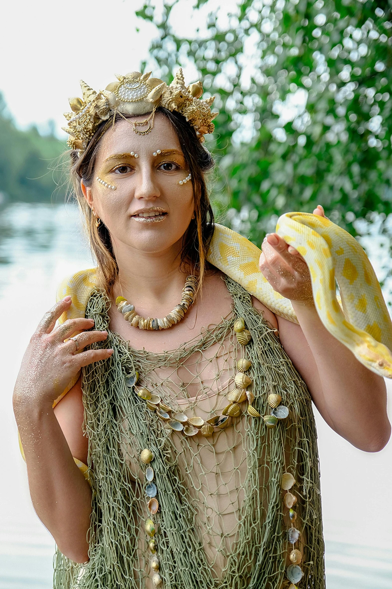 a woman with a snake around her neck, inspired by Károly Markó the Elder, pixabay contest winner, wearing loincloth, in lake, wearing seashell attire, draped in gold