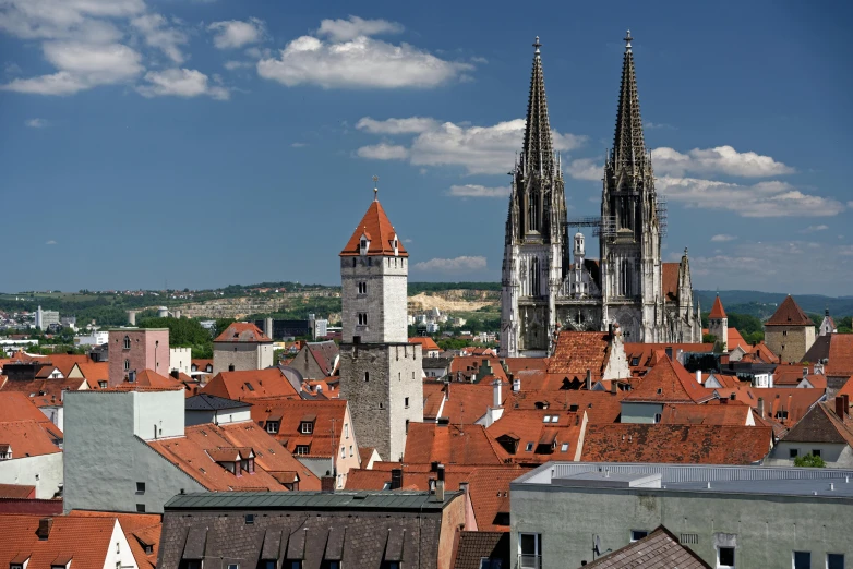 a view of a city from the top of a building, by Matthias Stom, pexels contest winner, renaissance, tall stone spires, blue sky, pink, square