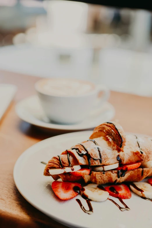 a close up of a plate of food on a table, unsplash, romanticism, fresh bakeries in the background, coffee, profile image, stroopwaffel