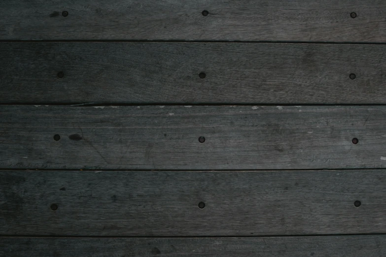 a red fire hydrant sitting on top of a wooden floor, an album cover, inspired by Agnes Martin, unsplash, minimalism, dark grey, seamless wood texture, panel of black, dark green tones