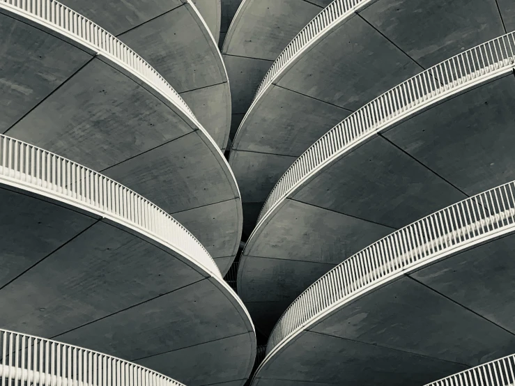 a black and white photo of a building, inspired by Zha Shibiao, unsplash contest winner, brutalism, white sweeping arches, desaturated colours, snake scales, symmetrical detail