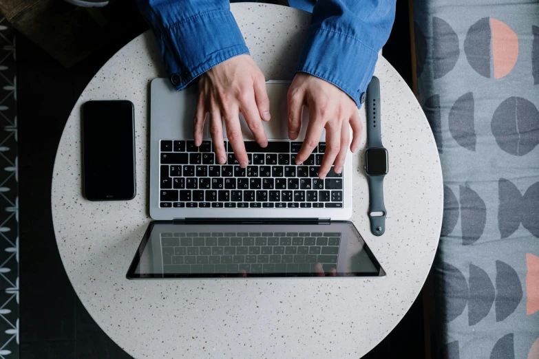 a person typing on a laptop on a table, by Carey Morris, trending on pexels, multi-part, background image, high angle, technical