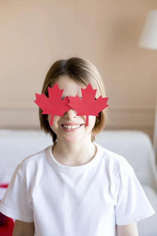 a little girl that is standing in front of a bed, canadian maple leaves, 2 eyes, g 7 summit press photos, boys