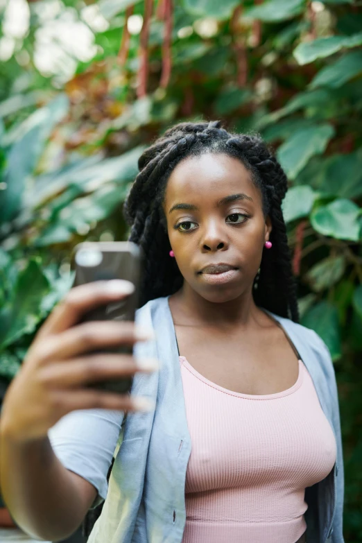 a woman taking a selfie with her cell phone, happening, portrait of ororo munroe, sharp focus », unhappy, gen z