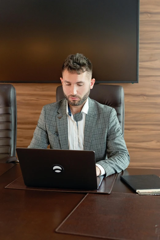 a man sitting at a table with a laptop, jakub gazmercik, avatar image, professional picture, zachary corzine