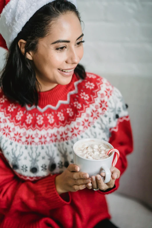 a woman in a santa hat holding a cup of hot chocolate, a portrait, by Julia Pishtar, trending on pexels, hurufiyya, wearing a cute top, inuit, promotional image, wholesome