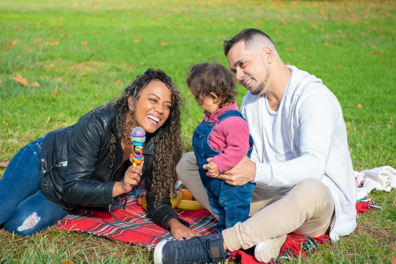 a man and woman sitting on a blanket with a child, pexels contest winner, happening, vanessa morgan, 15081959 21121991 01012000 4k, performing, tastes