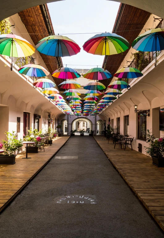 a walkway covered in lots of colorful umbrellas, trending on unsplash, quito school, inside a castle courtyard, color image, multiple stories, puerto rico