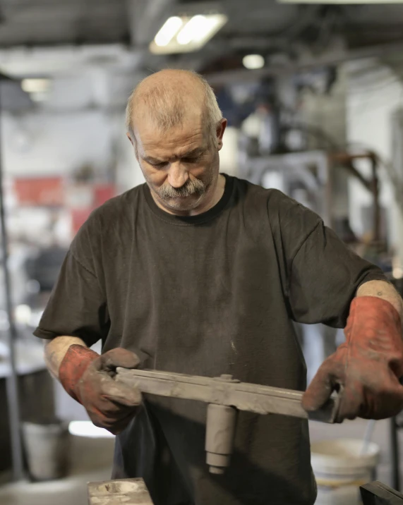 a man working with a hammer in a workshop, a bronze sculpture, by Joe Stefanelli, trending on reddit, lgbtq, white metal, older male, upset