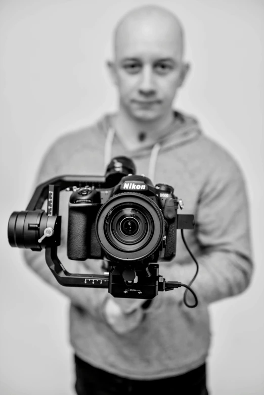 a black and white photo of a man holding a camera, irish youtuber, professional photo-n 3, robot photography, uploaded