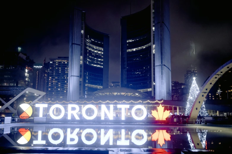 the toronto city sign is lit up at night, pexels contest winner, avatar image, 1980 photo, fan favorite, hyperrealism photo