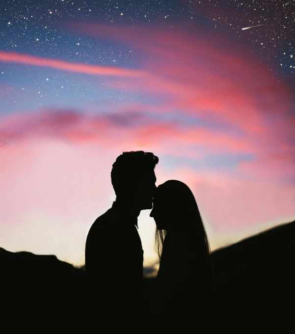 a couple standing next to each other under a sky full of stars, pexels contest winner, romanticism, profile image, sunset glow around head, dreaming of kissing a girl, profile picture