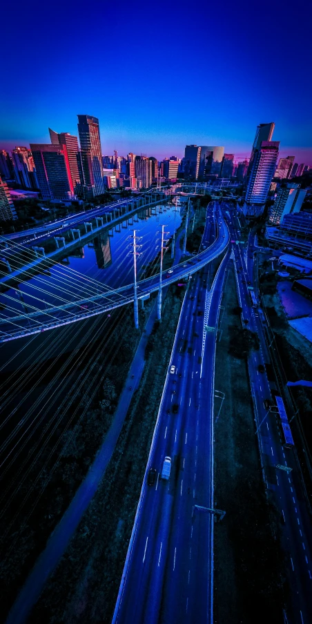 an aerial view of a city at dusk, an album cover, by Adam Marczyński, unsplash contest winner, futurism, illuminated blue neon lines, freeway, shanghai city, today\'s featured photograph 4k