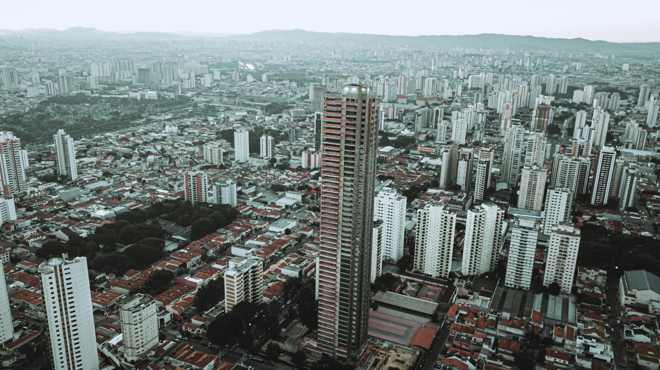 an aerial view of a city with tall buildings, by Alejandro Obregón, pexels contest winner, brutalism, salvador, view from side, single building, extremely high resolution