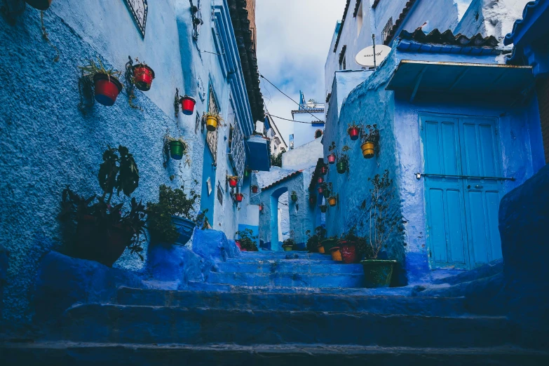 a narrow alley with blue walls and potted plants, by Julia Pishtar, unsplash contest winner, morrocan lamp, avatar image, city view, a bustling magical town