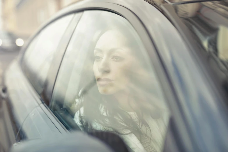 a woman looking out the window of a car, photorealism, unfocused, julia sarda, worksafe. cinematic, customers