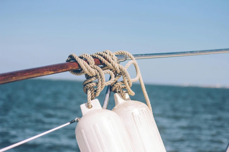 a close up of a rope on a boat, pexels contest winner, wind chimes, upon a peak in darien, calm ocean, camaraderie