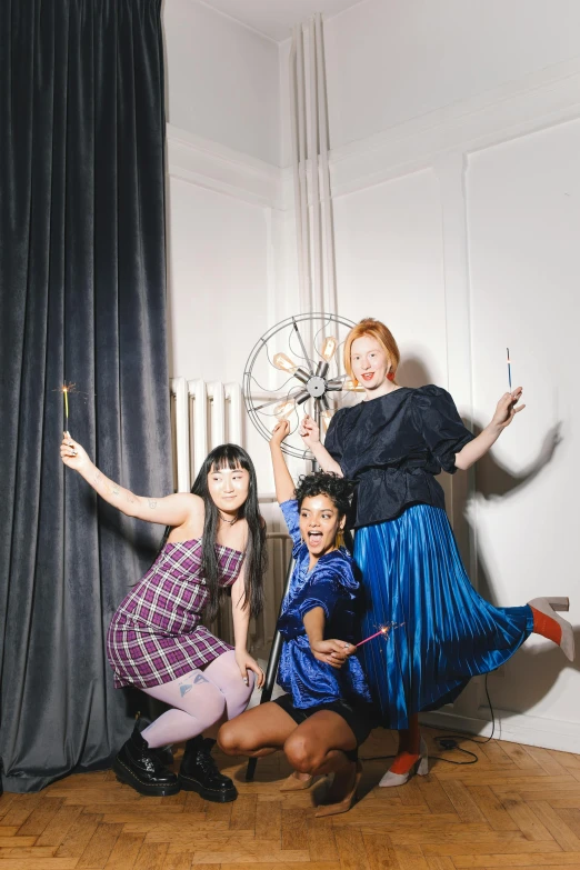 a group of women standing on top of a wooden floor, inspired by Cecil Beaton, unsplash, kitsch movement, holding a magic staff, 3 actors on stage, witch academia, photo booth