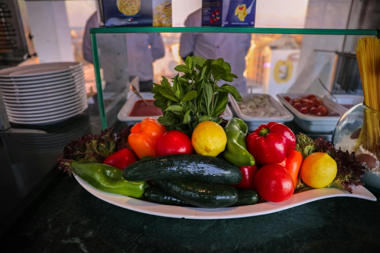 a plate of vegetables sitting on top of a counter, near the beach, profile image