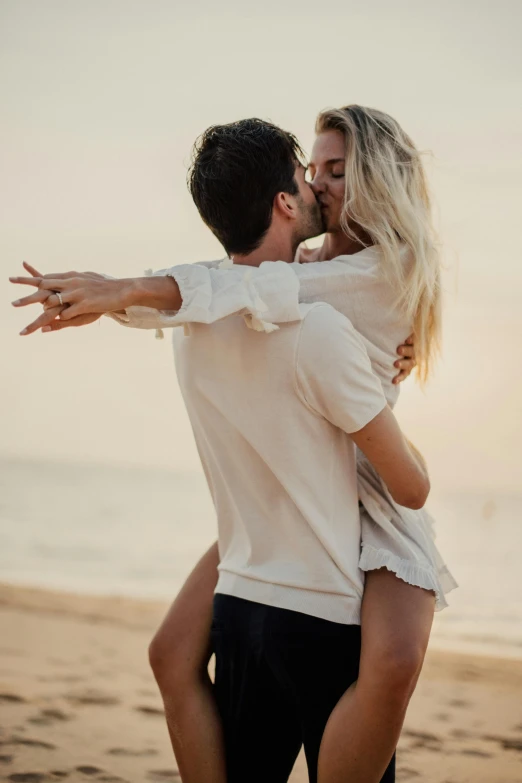 a man giving a woman a piggy back on the beach, pexels contest winner, romanticism, wearing a white button up shirt, making out, blonde, gif
