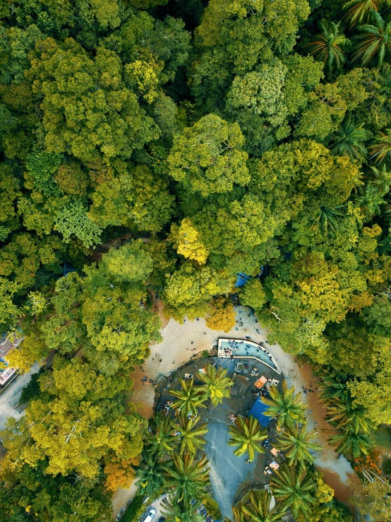 an aerial view of a park surrounded by trees, a screenshot, unsplash contest winner, hurufiyya, kuala lumpur, yellow and green, las pozas, bird\'s eye view