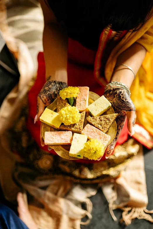 a close up of a person holding a plate of food, gifts, bollywood, dessert, rectangle