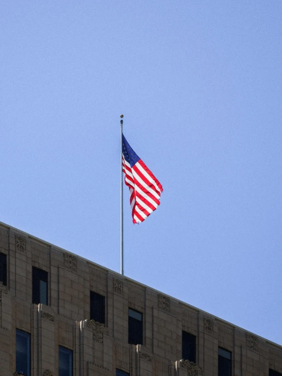 an american flag flying on top of a building, square, large)}], taken with sony alpha 9, high quality photo