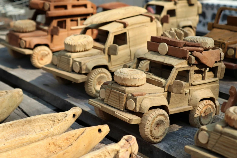 a bunch of wooden toys sitting on top of a table, cars parked, detailed wood carving, thumbnail, crafts and souvenirs