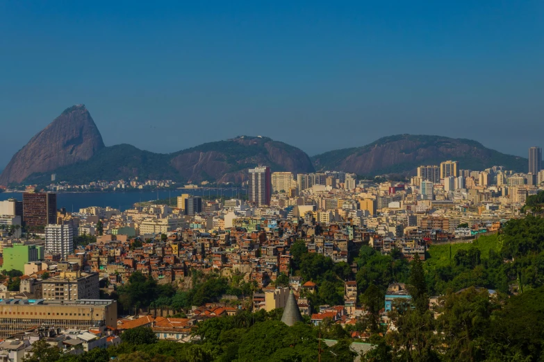 a view of a city with a mountain in the background, by Elsa Bleda, pexels contest winner, cristo redentor, slide show, sunny summer day, 8 k hi - res