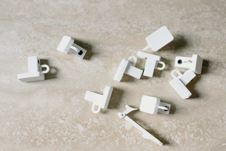 a bunch of white legos sitting on top of a table, inspired by Rachel Whiteread, unsplash, computer art, broken shackles, usb ports, white travertine terraces, white wood