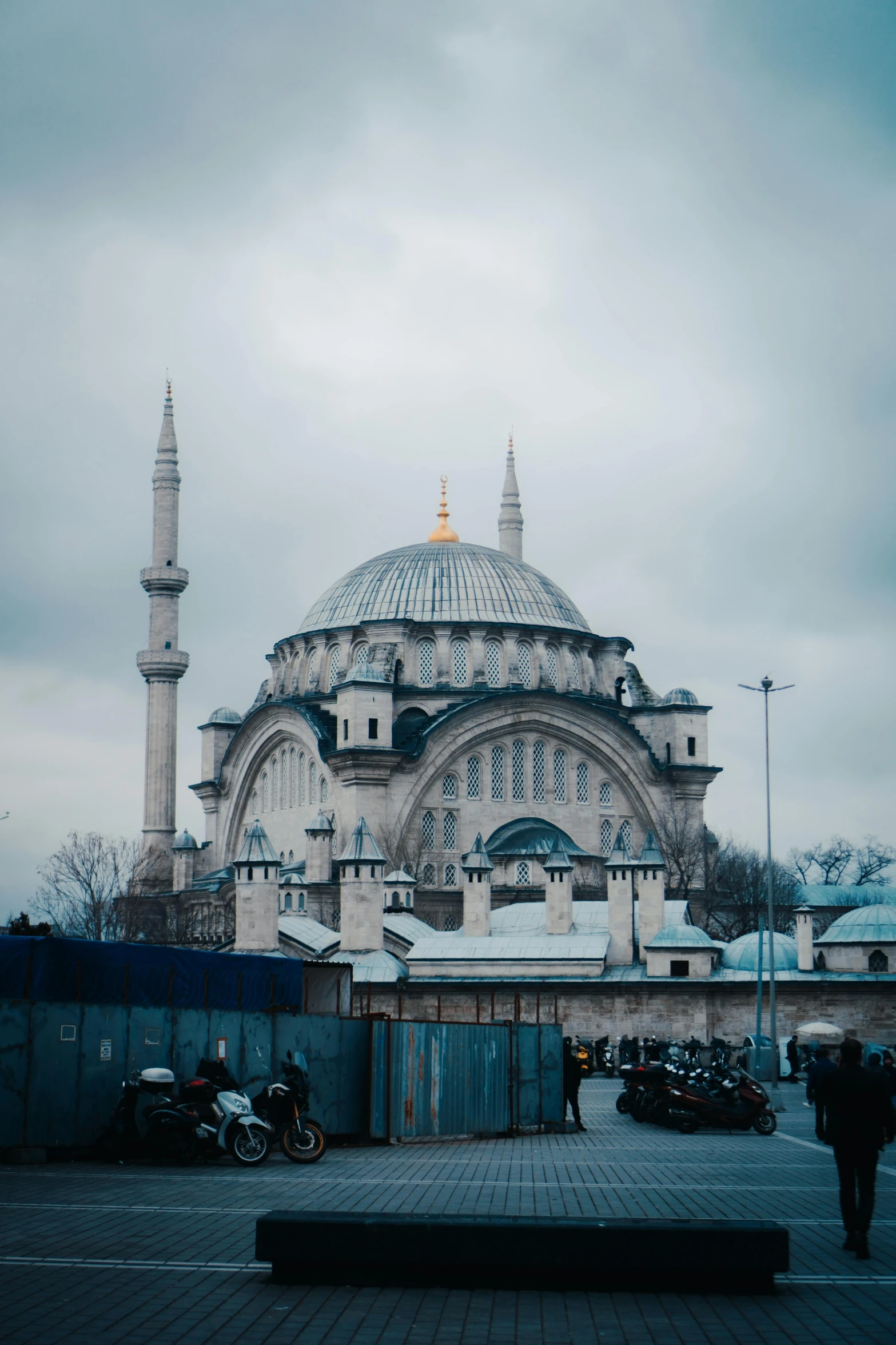 a group of people walking in front of a large building, a colorized photo, pexels contest winner, hurufiyya, with beautiful mosques, 2 5 6 x 2 5 6, blue and gray colors, turkey