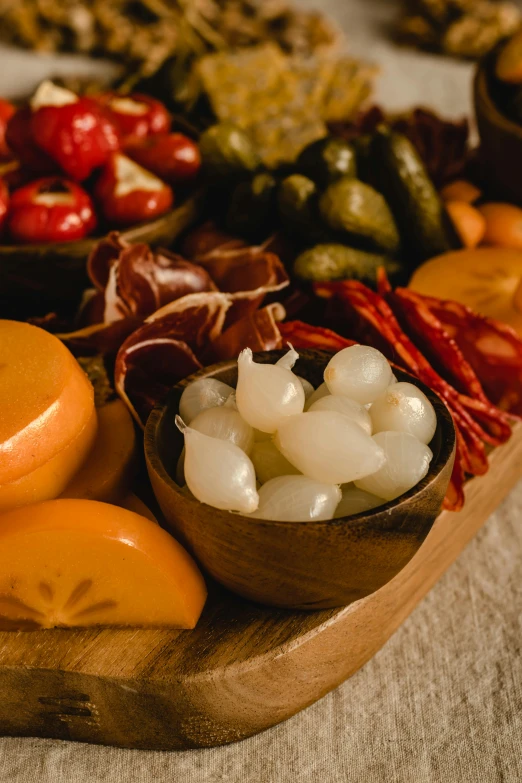 a wooden tray filled with assorted fruits and vegetables, cheese and pepperoni, thumbnail, bells, spanish