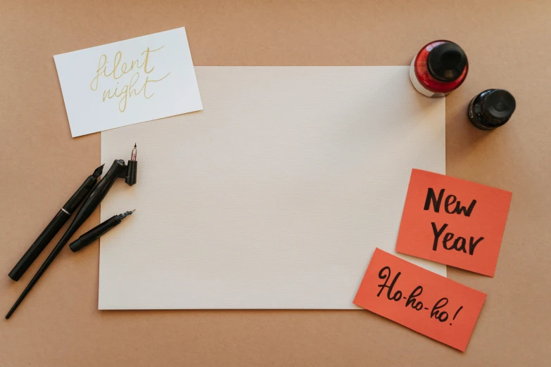 a piece of paper sitting on top of a table, trending on pexels, mail art, new years eve, background image, whiteboard, paint on canvas