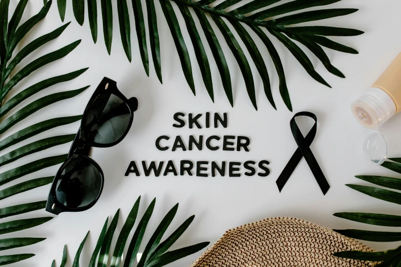 a hat, sunglasses, and palm leaves on a white surface with the words skin cancer awareness, a photo, by Julia Pishtar, trending on pexels, renaissance, ribbon, a bald, skincare, ( ( dark skin ) )