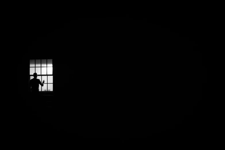 a man standing next to a window in a dark room, by Zsolt Bodoni, pexels contest winner, minimalism, prisoner, computer wallpaper, mono eye window, 3840 x 2160