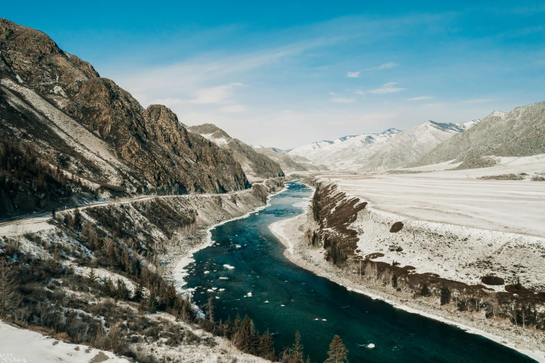 a river running through a snow covered valley, by Muggur, pexels contest winner, hurufiyya, erosion channels river, thumbnail, mongol, wide river and lake