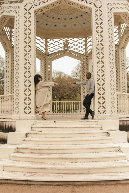 a man and a woman standing in front of a gazebo, an album cover, by Lily Delissa Joseph, pexels contest winner, arabesque, dancing with each other, london, steps, white