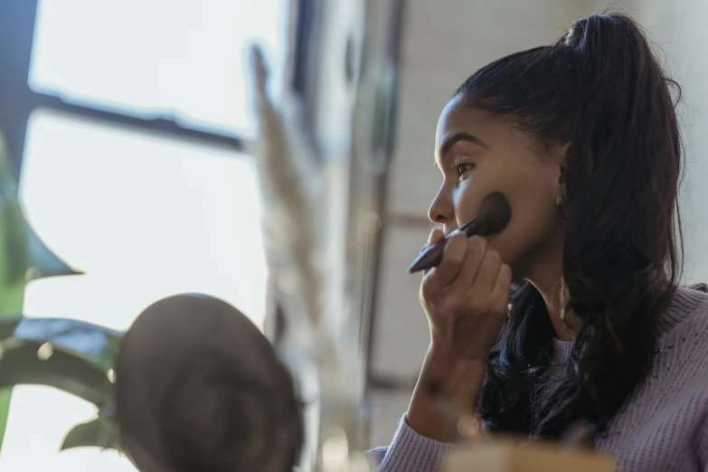 a woman brushes her teeth in front of a mirror, trending on pexels, brown skin. light makeup, in a workshop, avatar image