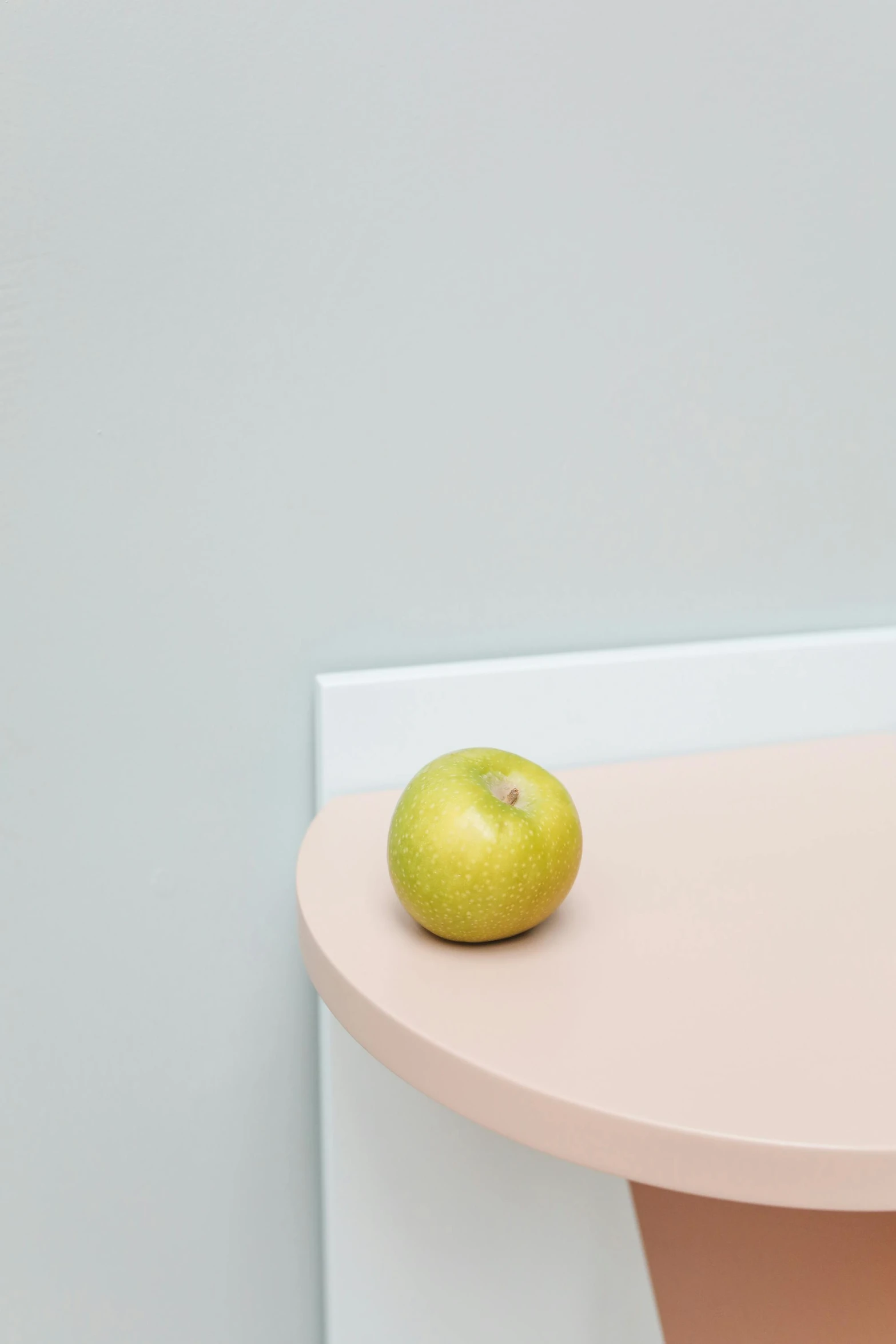 a green apple sitting on top of a pink table, by Harvey Quaytman, postminimalism, wall corner, smooth porcelain skin, ilustration, bench