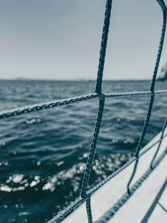 a black and white photo of a boat in the ocean, pexels contest winner, happening, subject made of white mesh rope, thick blue lines, closeup photograph, tournament