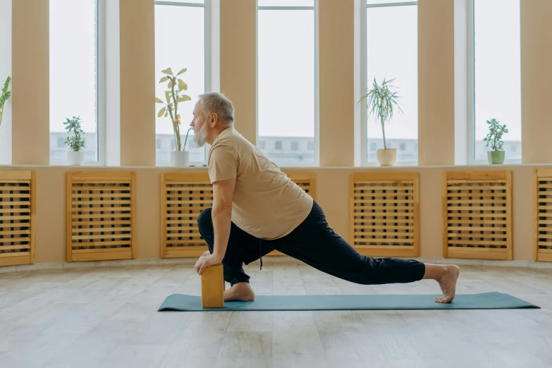 a man doing a yoga pose on a yoga mat, pexels contest winner, portrait of hide the pain harold, long trunk holding a wand, avatar image, indoor picture