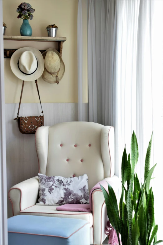 a white chair sitting in a living room next to a window, featured on pinterest, pink cowboy hat, hotel room, houseplant, white wings