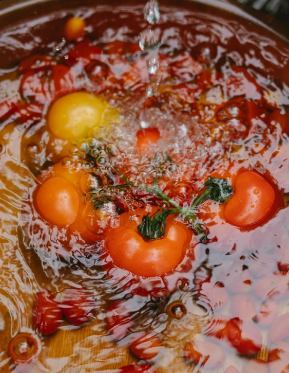 a pot filled with tomatoes sitting on top of a wooden table, pexels contest winner, process art, stands in a pool of water, aspic, ignant, thumbnail