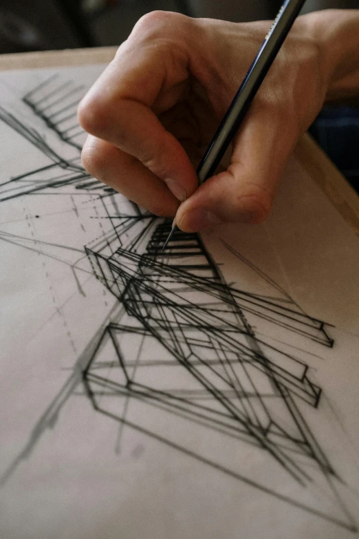 a person drawing on a piece of paper with a pencil, inspired by Vassily Maximov, reddit, conceptual art, daniel libeskind, simetrical medium shot, promo image, complex pattern