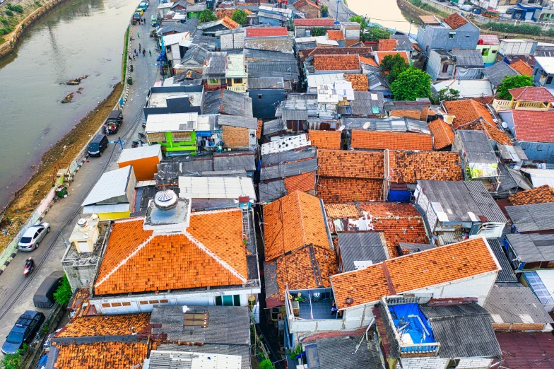 an aerial view of a city with a river in the background, by Daniel Lieske, pexels contest winner, tiled roofs, sri lanka, orange roof, thumbnail