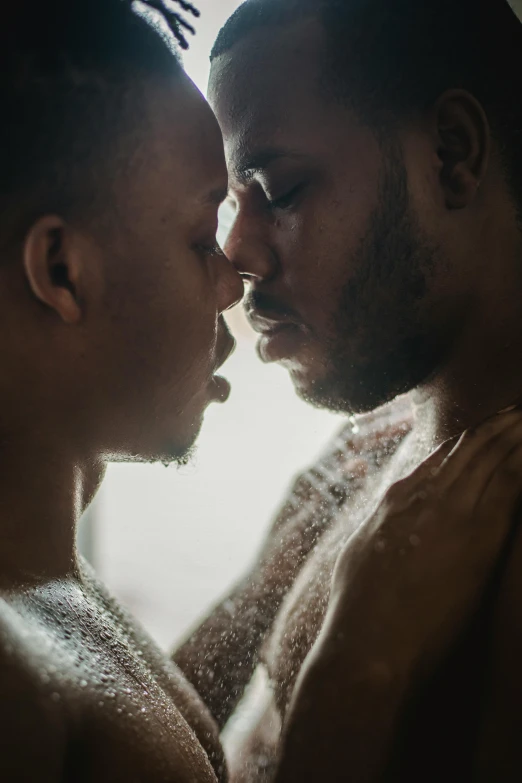 a man and a woman standing next to each other, a photo, by Cosmo Alexander, trending on unsplash, lesbian kiss, oiled skin, two young men, looking outside