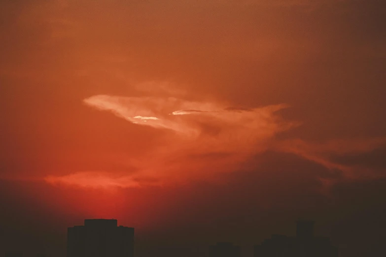 the sun is setting over the city skyline, inspired by Elsa Bleda, pexels contest winner, tonalism, red cumulonimbus clouds, alessio albi, orange gradient, red colored
