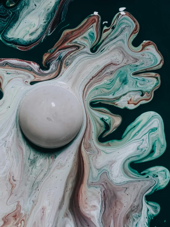 a white egg sitting on top of a marble slab, inspired by Otto Piene, trending on unsplash, abstract art, colorful swirls of paint, full of greenish liquid, where the planets are candy, alessio albi