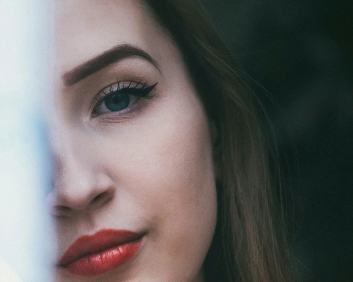 a close up of a woman with red lipstick, trending on pexels, realism, slender symmetrical face, half woman, distant thoughtful look, girl with white eyes